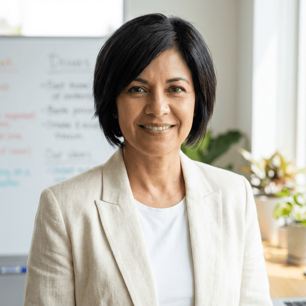 Elena Rodriguez, team lead in a blazer, in a bright home office with natural light